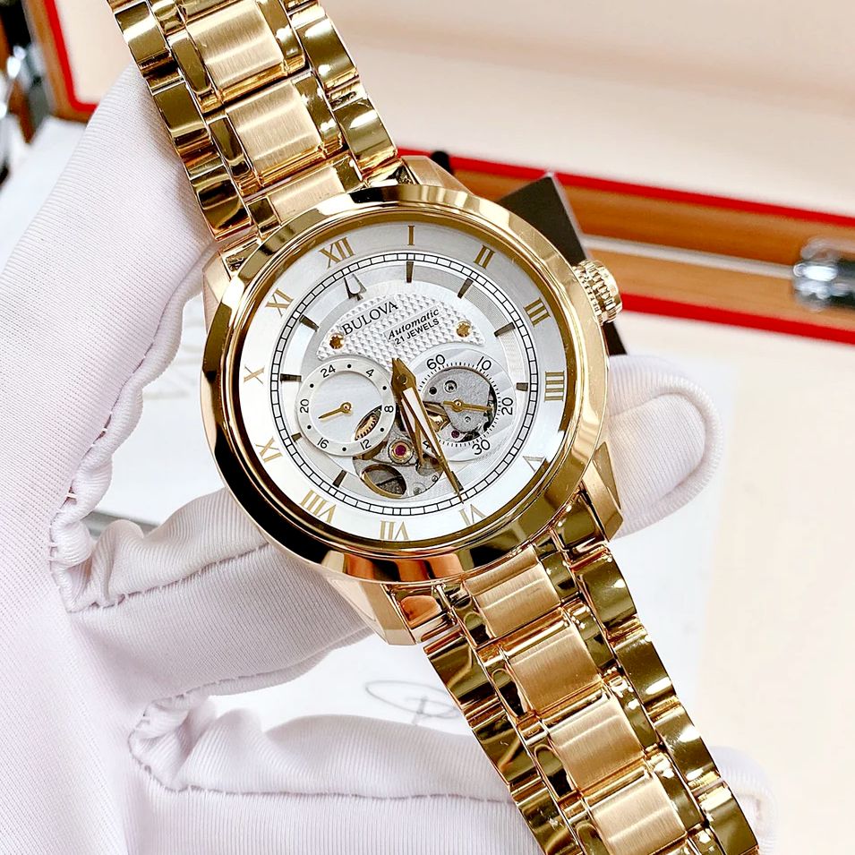 Bulova Relógio masculino clássico Sutton automático com 4 ponteiros, submostrador 24 horas, abertura aberta, corda automática, 97A108 – Dourado na Amazon